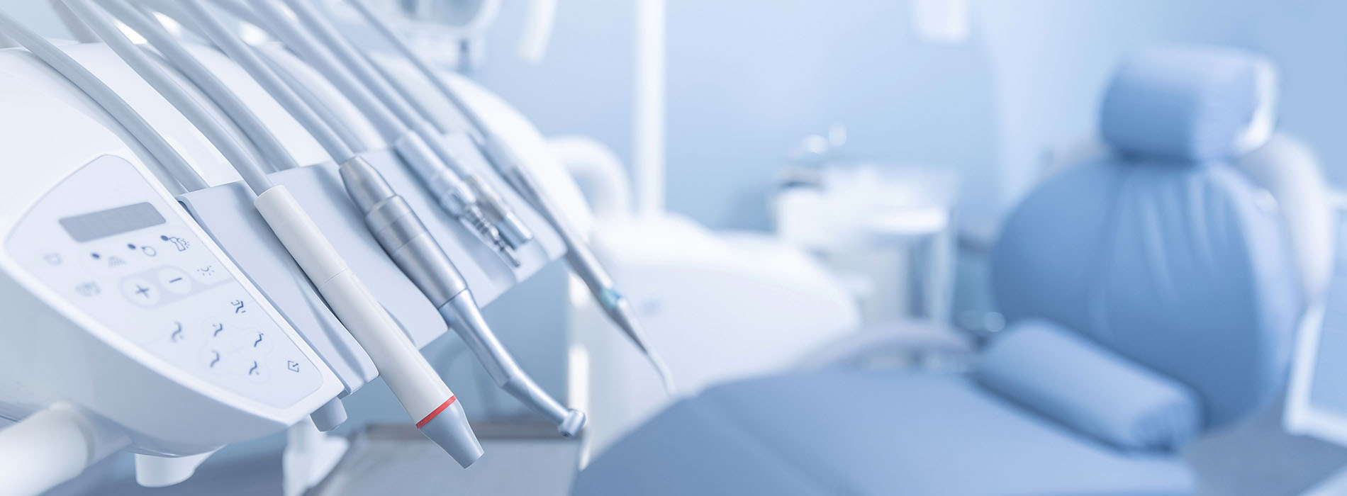 The image is a close-up of a medical or dental office setting, featuring various pieces of equipment and instruments typically found in such environments.