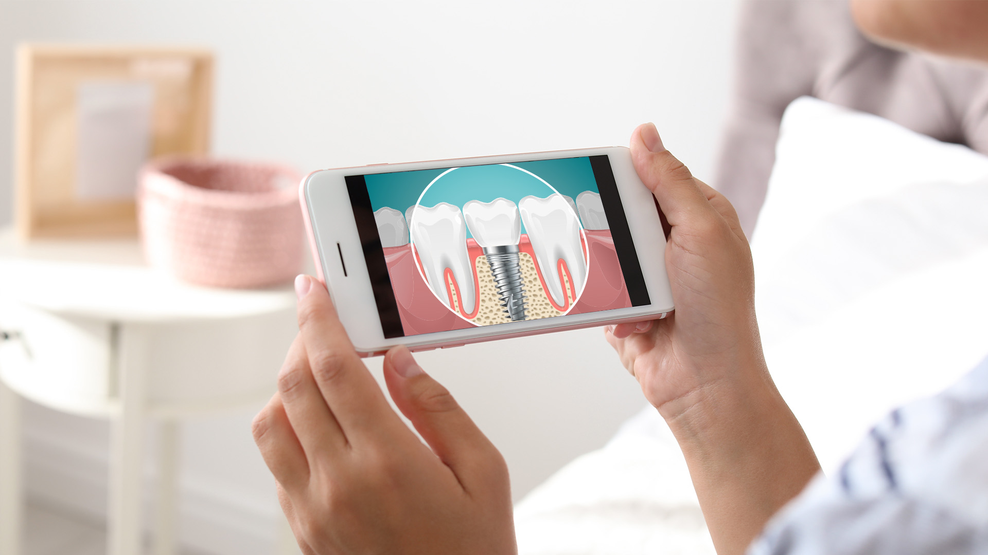 The image shows a person holding a smartphone displaying an illustration of a tooth with a cavity and a magnified view of the tooth s interior, possibly for educational or dental health purposes.