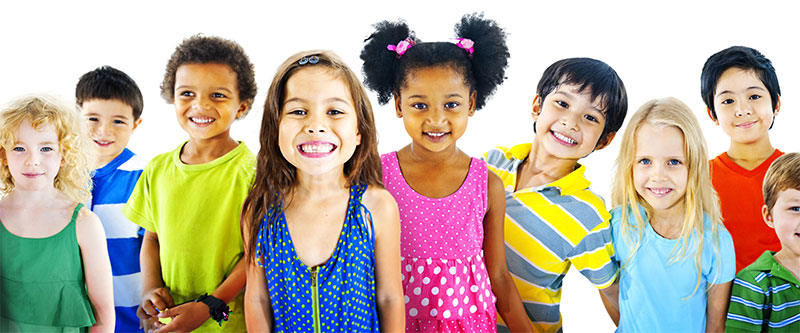 The image features a diverse group of children and young adults, possibly in an educational or recreational setting, smiling at the camera.