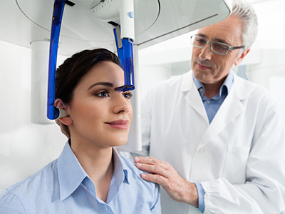 A medical professional examining a person s head with advanced imaging technology.